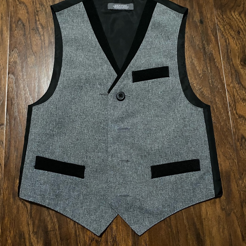 Button down shirt with black vest and bow tie